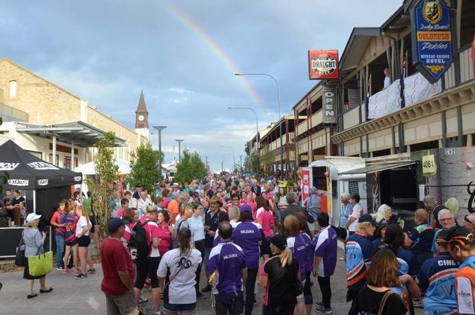 Thousands of people fill the main street of a country town for a street party.