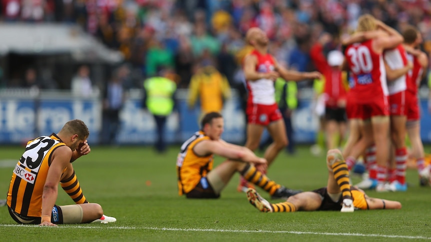 Hawthorn's Lance Franklin and David Hale slump to the ground after their grand final loss to Sydney.