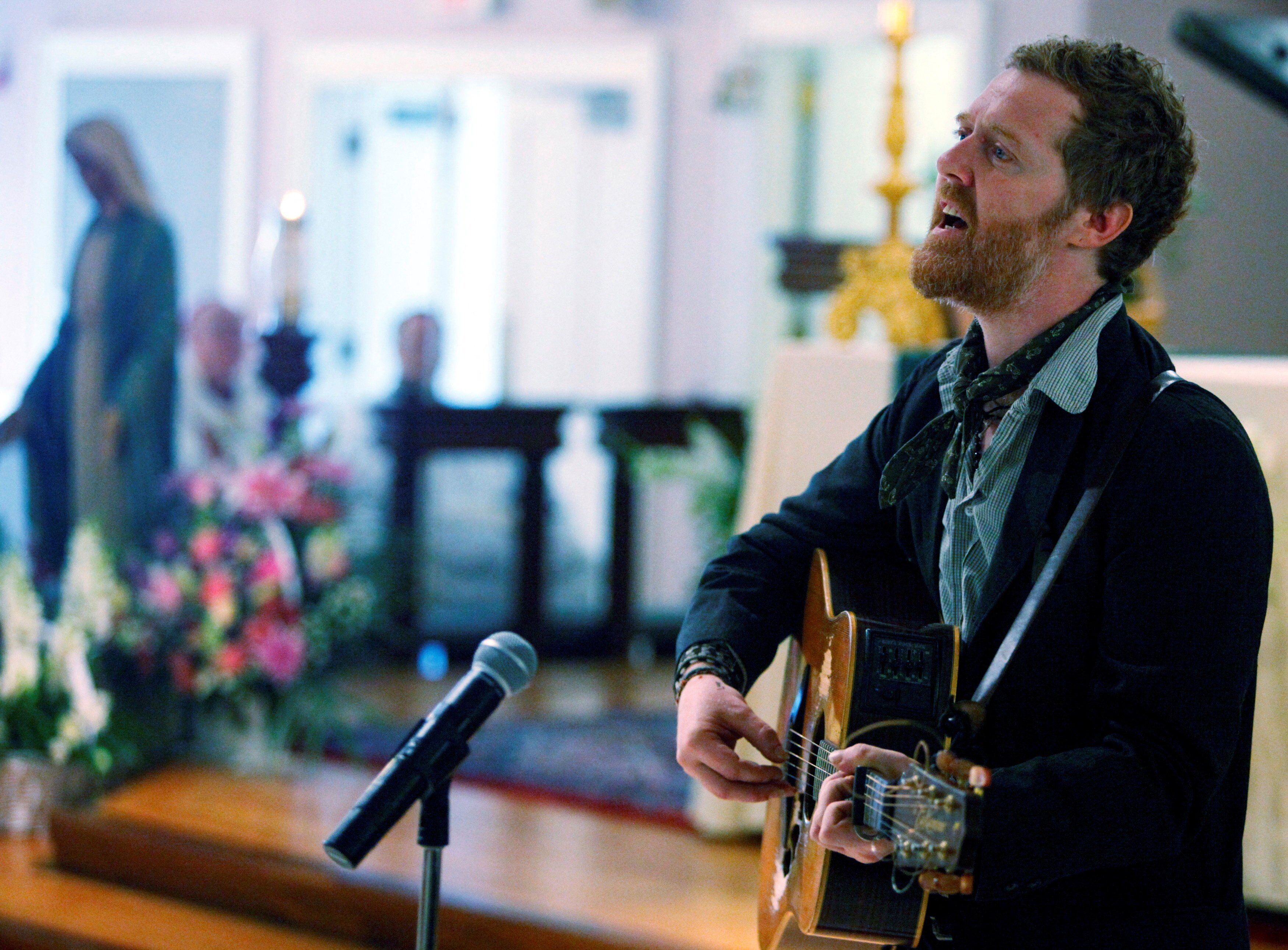 Glen Hansard singing and playing guitar. 
