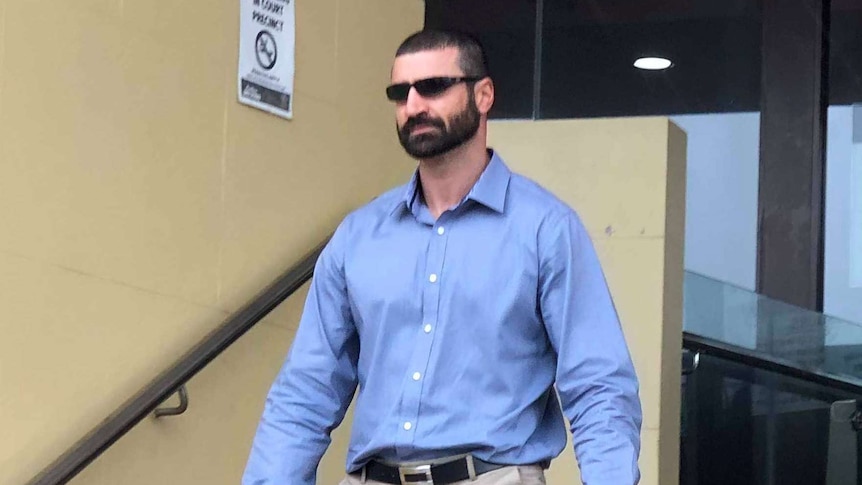 John Peros wearing sunglasses leaving the Mackay court house.