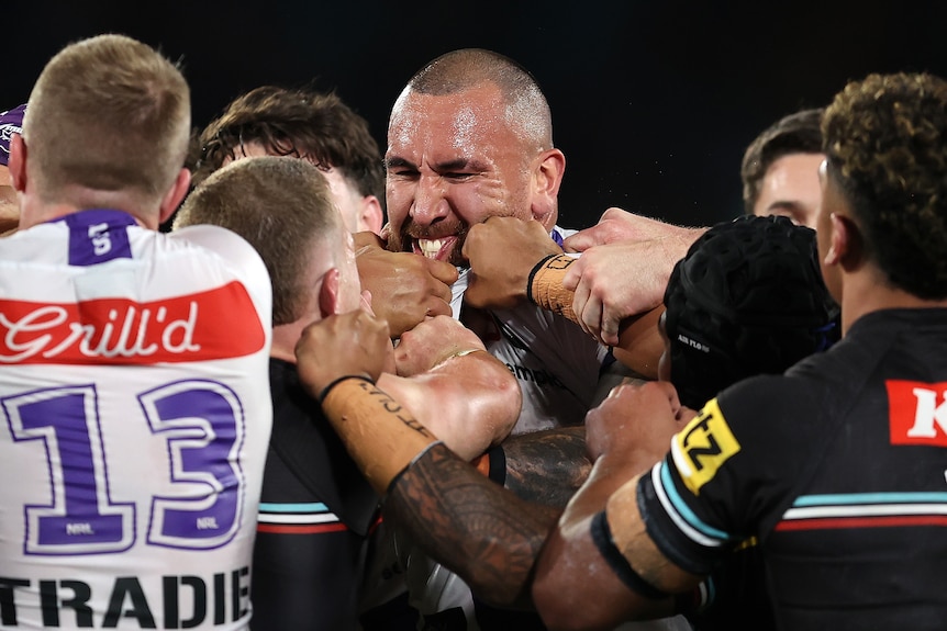 Two rugby league players face off during a match