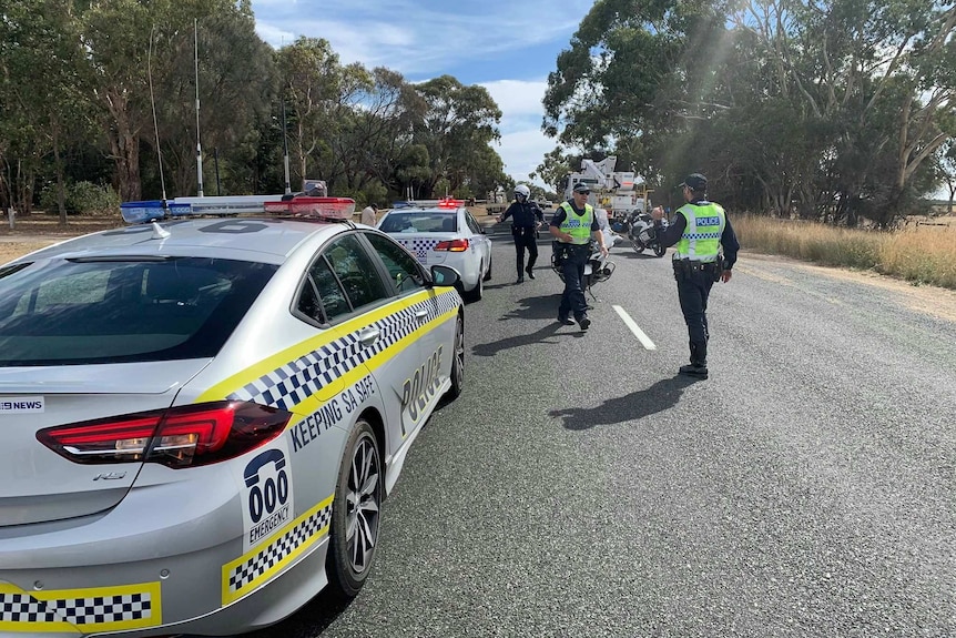 Police on the road near the scene of a helicopter crash in south-east SA