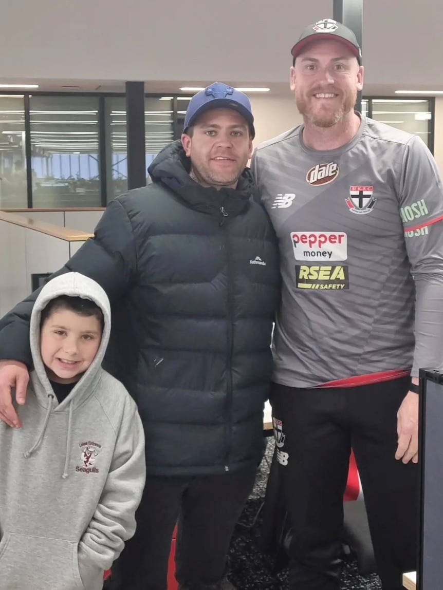 Jai Walker and his son Kaiden meet Hawks great Jarryd Roughead.