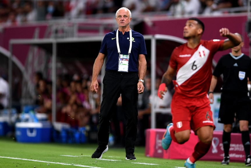 Graham Arnold watches on the sidelines as Australia players take on Peru