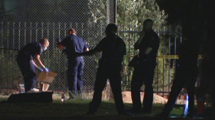 Police investigate the site where a body was found.