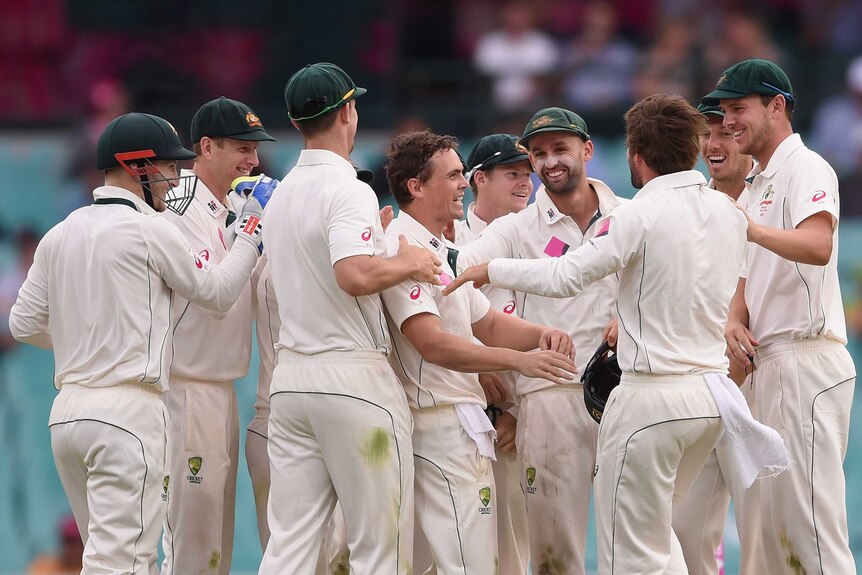 Steve O'Keefe of Australia is congratulated by team mates after dismissing Jason Holder of West Indies caught by Joe Burns during day one of the third Test