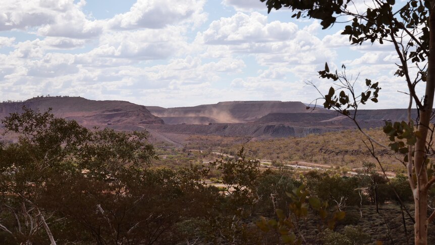 A wide shot of a large mine off in the distance.