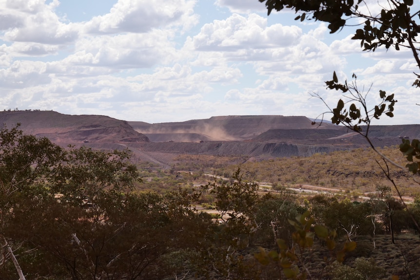 A wide shot of a large mine off in the distance.