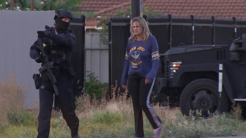 A woman walks next to a Star Force officer