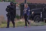 A woman walks next to a Star Force officer