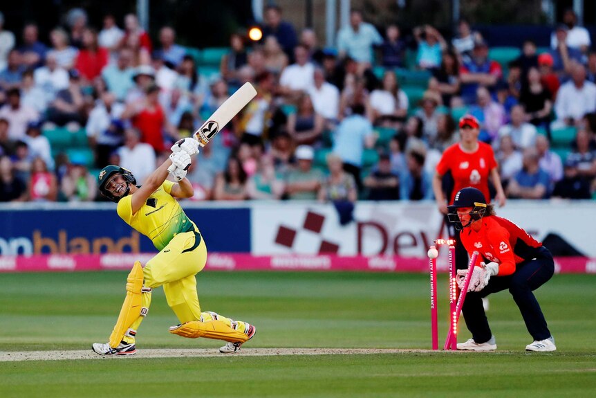 Australia's Ashleigh Gardner swipes at the ball but misses as it hits the wickets.