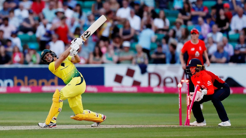 Australia's Ashleigh Gardner swipes at the ball but misses as it hits the wickets.