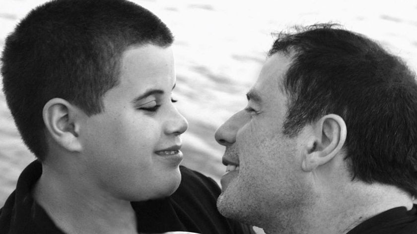 Actor John Travolta, right, shares a moment with his son Jett