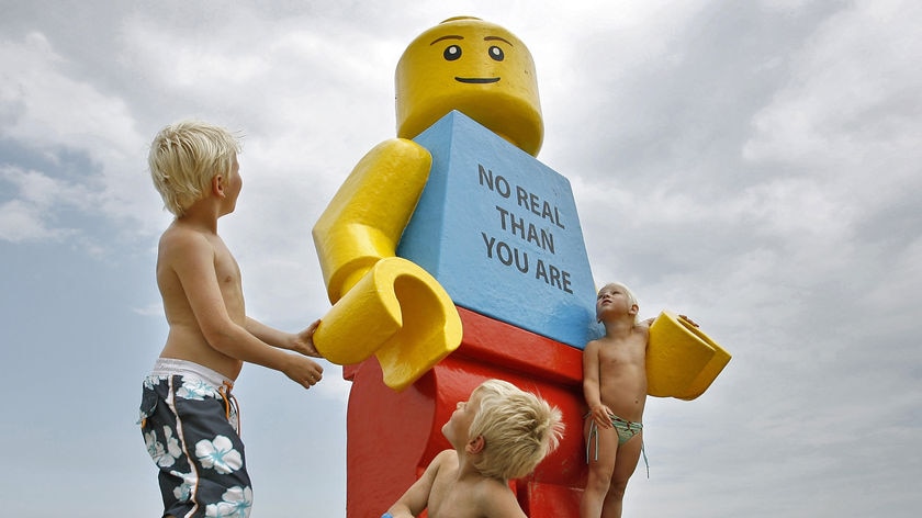 Washed up: Children play around the giant Lego man