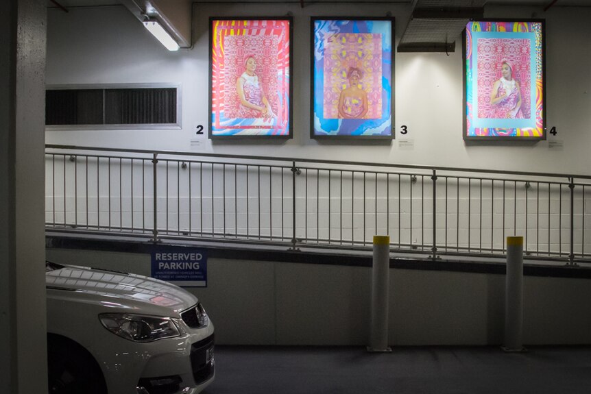 Light boxes illuminate artwork by Queensland Indigenous artist Hannah Bronte in a Brisbane car park.