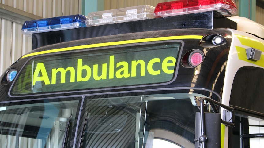 The close up shot of the Ambulance sign on the bus.