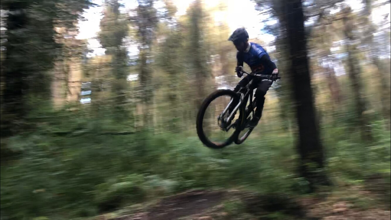 A mountain bike rider in the air.
