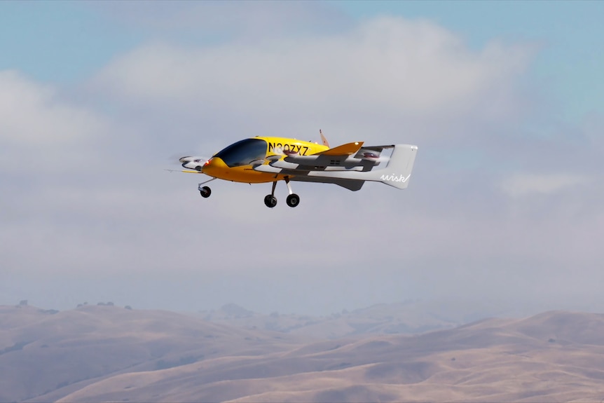 A small yellow air taxi in the sky. 
