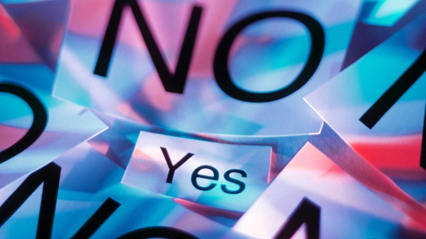 Pieces of paper on a table which read 'no' surrounding a note stating 'yes'.