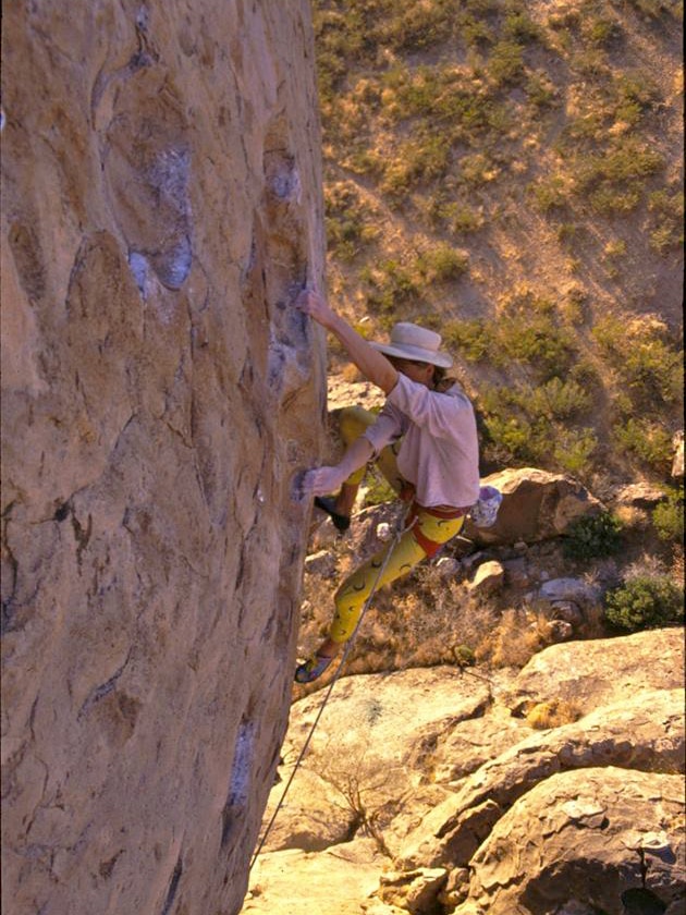 Paul Pritchard vertical climbing up a rock face.