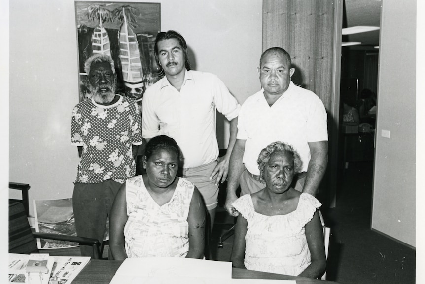 A historic photo of five Indigenous people in a room.