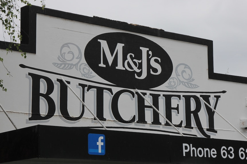 Black and white sign with M&J's Butchery on it 