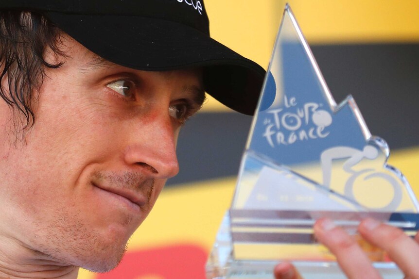 Geraint Thomas celebrates on podium after 11th stage at Tour de France