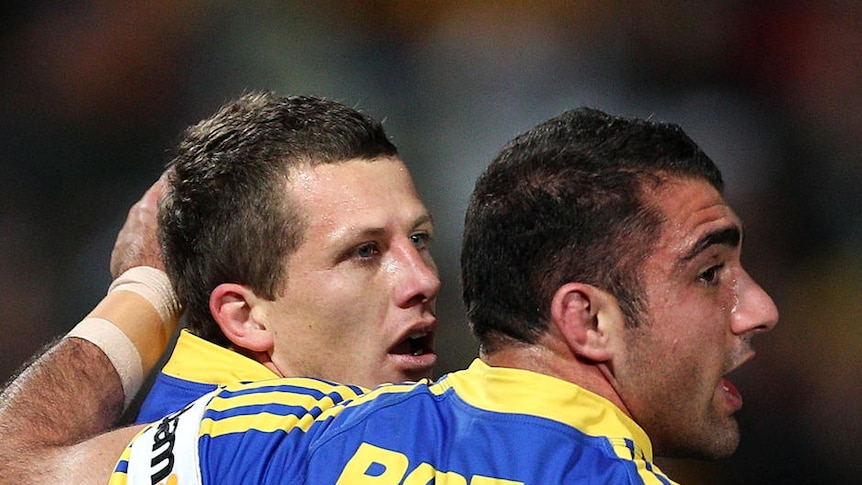 Try time: Jordan Atkins is congratulated by NSW prop Tim Mannah.