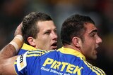 Try time: Jordan Atkins is congratulated by NSW prop Tim Mannah.