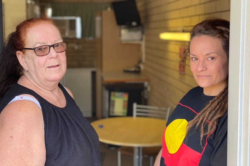 Two women stand in the doorway of a motel on the Sunshine Coast