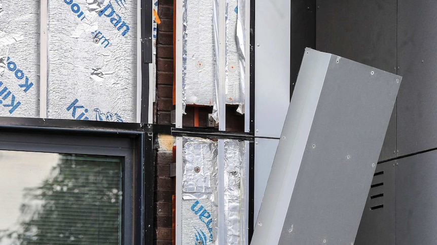 Workers remove cladding from Whitebeam Court, in Pendleton, Manchester, Monday June 26, 2017.