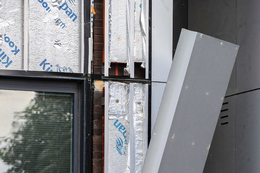 Workers remove cladding from Whitebeam Court, in Pendleton, Manchester, Monday June 26, 2017.