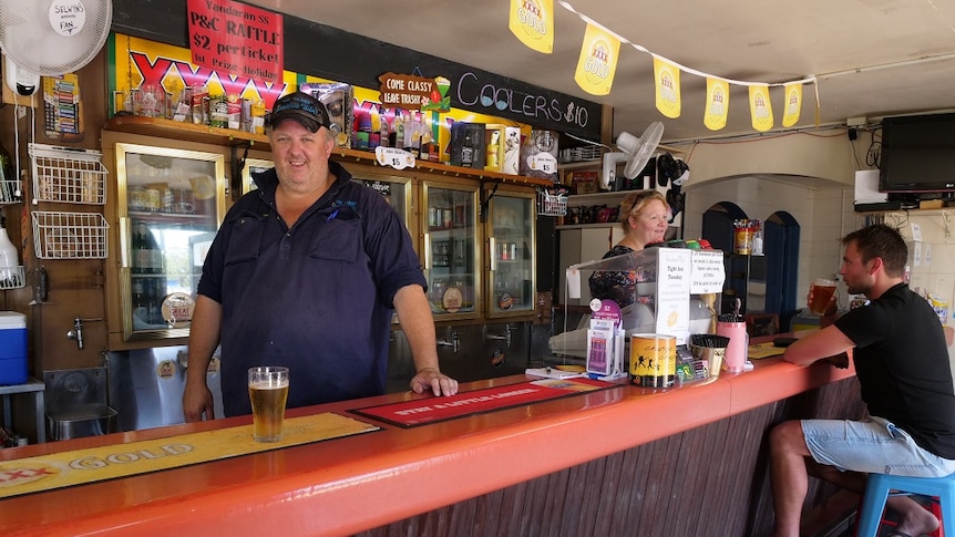 A country publican stands behind the counter of the Yandaran pub in Queensland