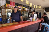 A country publican stands behind the counter of the Yandaran pub in Queensland