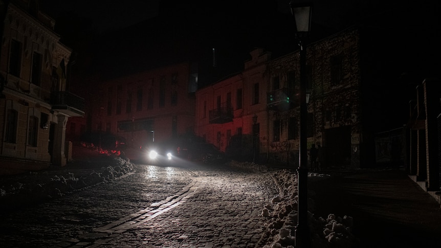 A vehicle drives past during a blackout.