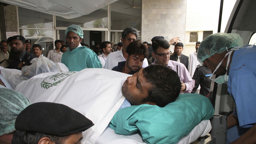 Pakistan hospital staff carry Sri Lankan cricket player Tharanga Paranavitana at a local hospital