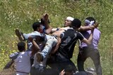 Demonstrators carry a wounded fellow protester who was hit by fire from Israeli forces