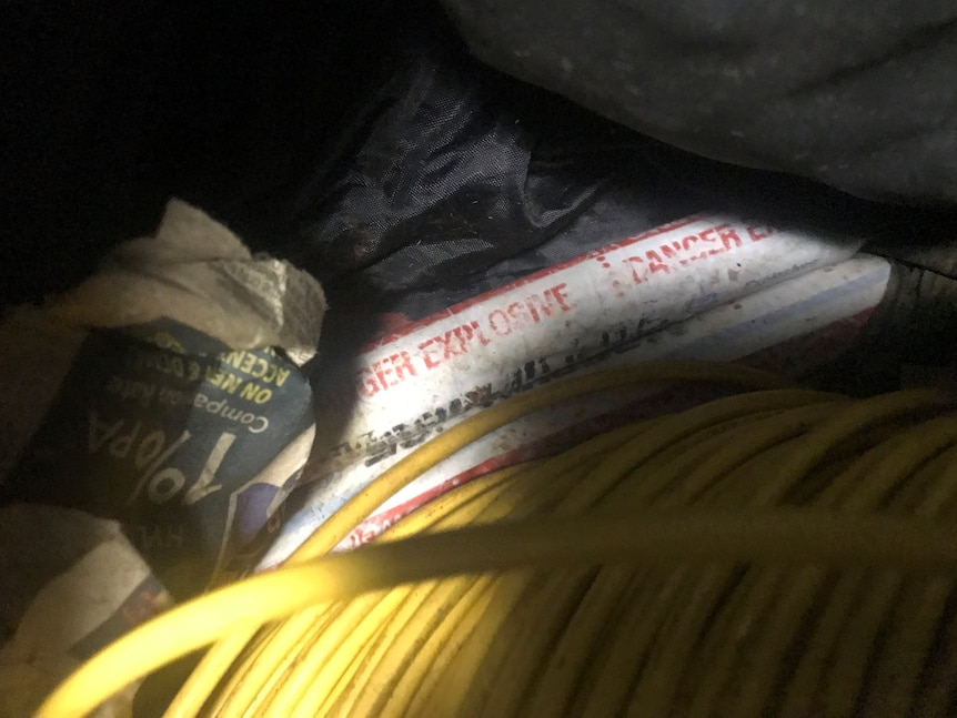 Writing can be seen on the white explosives saying 'EXPLOSIVE' and 'DANGER'.