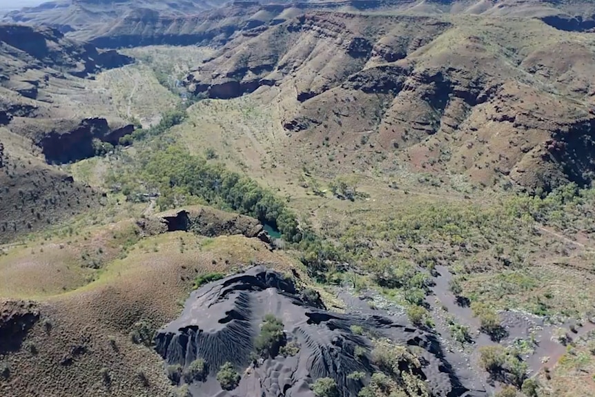 a valley with grey hills