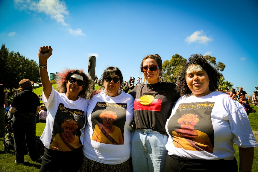 Four people grouped together at a protest in Melbourne.