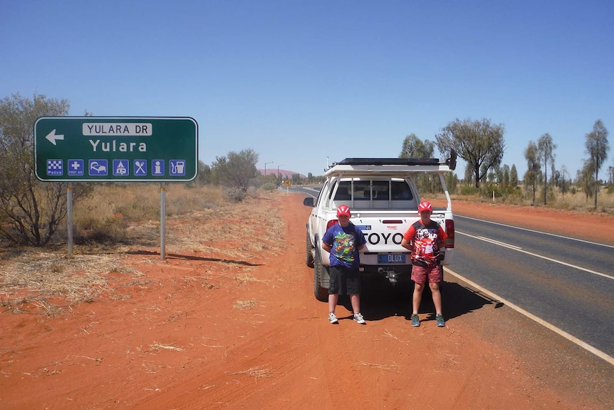 John Pyper's children stand in front of their father's ute at Yulara.