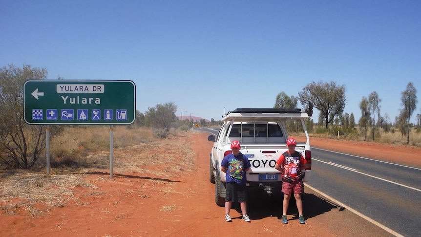 John Pyper's children stand in front of their father's ute at Yulara.