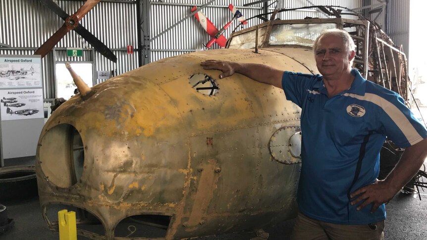 Evans Head Memorial Aerodrome President rod Kinnish standing next to the Avro Anson on display in the aircraft museum