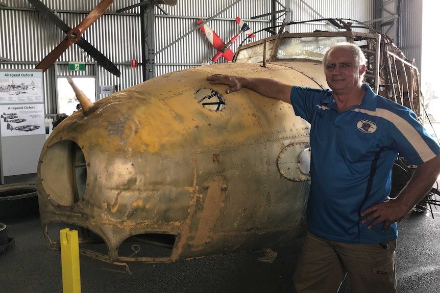 Evans Head Memorial Aerodrome President Rod Kinnish standing next to the Avro Anson on display in the aircraft museum