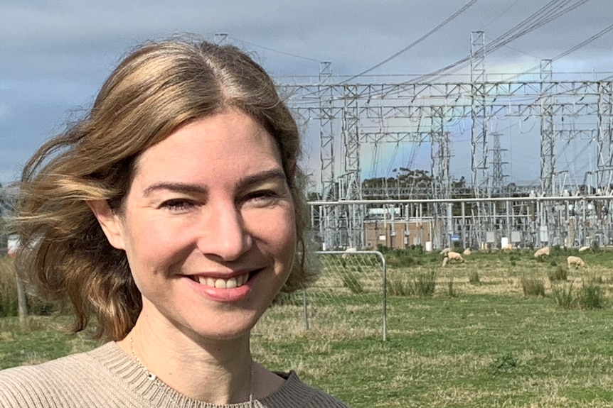 Woman in front of electrical substation