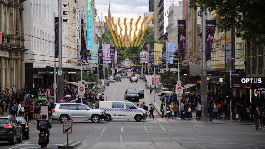 Looking up Bourke Street towards Swanston Street, street is closed off by police and fire trucks