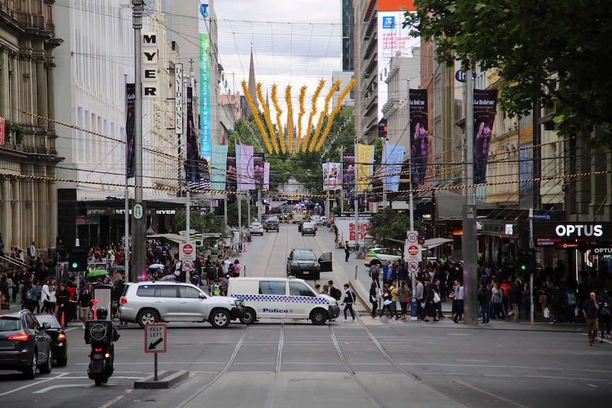 Looking up Bourke Street towards Swanston Street, street is closed off by police and fire trucks