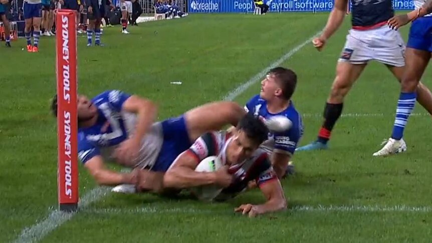 Sydney Roosters' Joseph Suaalii almost scores a try under Canterbury Bulldogs tacklers.