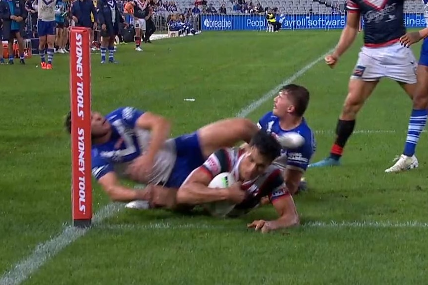Sydney Roosters' Joseph Suaalii almost scores a try under Canterbury Bulldogs tacklers.