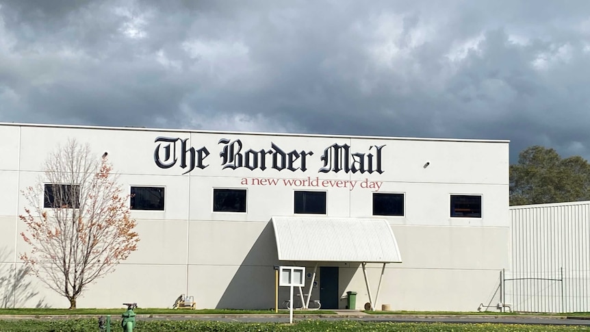 close up of Border Mail sign and building